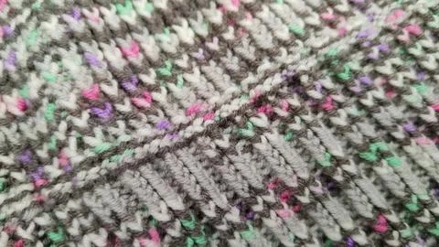 Knitted wool background made of melange yarn Stock Photos