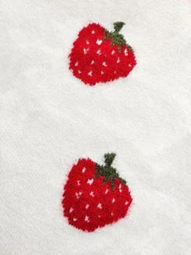 Knitted wool fabric with strawberry pattern. Soft textile material Фото