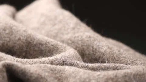Knitted Wool over black background. Real Natural beige color craft wool mohair Stock Footage 340612002