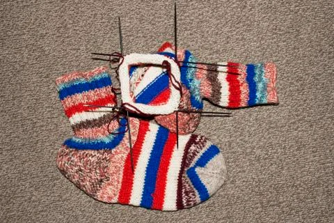 Knitted wool socks.Background knitting wool socks spokes. Stock Photos