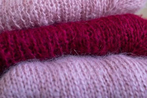 Knitted wool sweaters folded in layers. Stock-Fotos