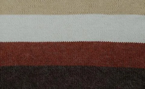 Knitted woolen striped colorful pattern fabric winter clothing texture. Stock Photos