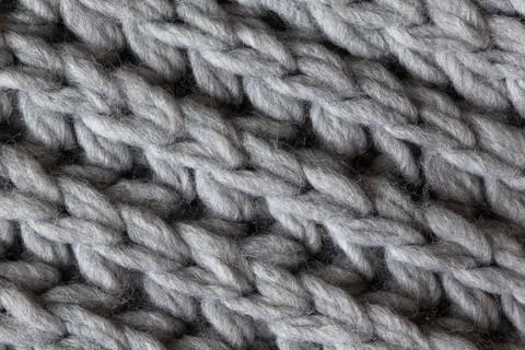 Knitted woolen textured surface, macro. Soft grey merino wool pattern Stock Photos