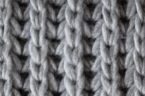 Knitted woolen textured surface, macro. Soft grey merino wool pattern backdro Stock Photos