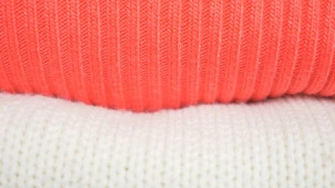 Knitten things. Sweaters are lying a pile. 4k, close-up, slow-motion, cozy Vidéo 87499215