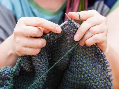 Knitter knits pullover from wool Stock Photos