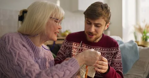 Knitters work together on cozy project at home during a relaxing afternoon Video stock 308388160