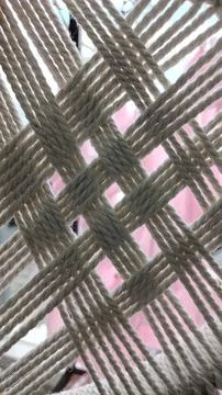 Knitting with beige thread made of wool. Photo in macro mode on the background 写真素材