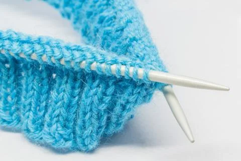 Knitting with a blue wool Stock Photos