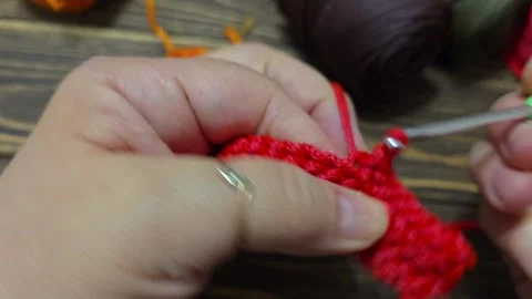 Knitting a cord pattern with a crochet hook. Step-by-step instructions Stock Footage 312055003