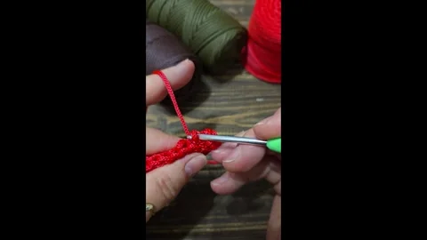 Knitting a cord pattern with a crochet hook. Step-by-step instructions Stock Footage 312055223