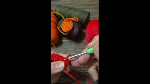 Knitting a cord pattern with a crochet hook. Step-by-step instructions Stock Footage 312055259