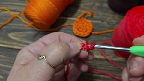 Knitting a cord pattern with a crochet hook. Step-by-step instructions Stock Footage 312055312