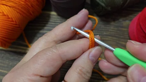 Knitting a cord pattern with a crochet hook. Step-by-step instructions Stock Footage 312055727