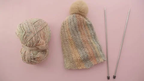 Knitting a cozy hat with pom pom on soft yarn Video stock 315144735