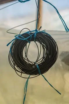 Knitting electrical wire hanging on the window Stock Photos