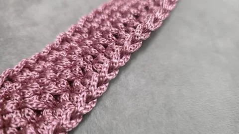 Knitting elements of a pink women's bag, hand knitting with a long handle. Stock Photos