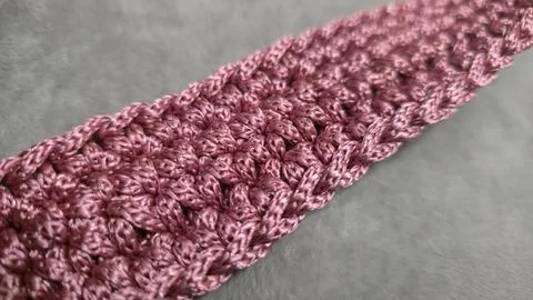 Knitting elements of a pink women's bag, hand knitting with a long handle. Stock Photos