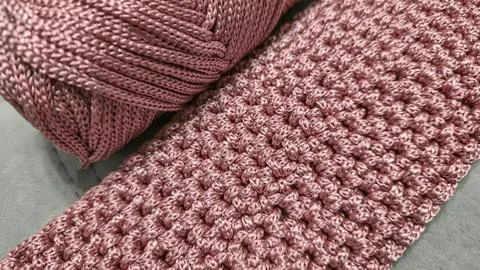 Knitting elements of a pink women's bag, hand knitting with a long handle. Stock Photos