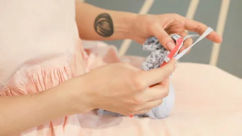 Knitting hand made hobby. Young woman hands with coll hipster tattoo working Stockbeeldmateriaal 88997734