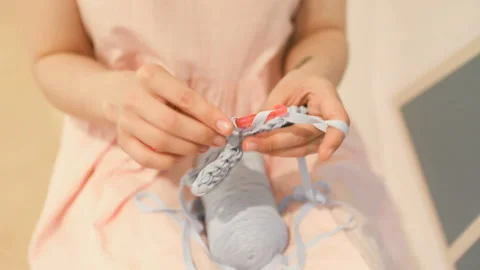 Knitting hand made hobby. Young woman hands with coll hipster tattoo working Stockbeeldmateriaal 88997792