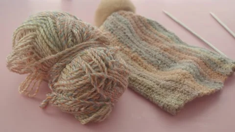 Knitting a hat with yarn and needles in a cozy setting Stock Footage 323150218
