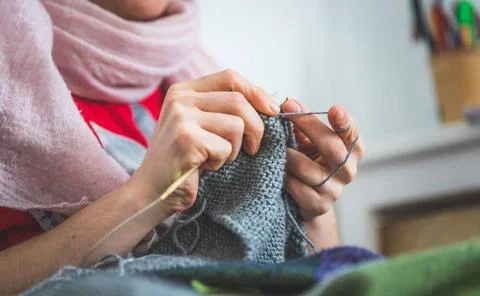Knitting at home: Close up of wool, thread and female fingers Close up of ... Stock Photos