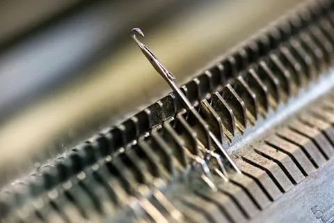 Knitting machine needle closeup Stock Photos