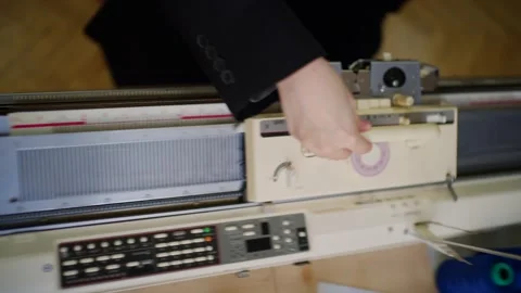 Knitting machine in operation with close up on manual carriage movement for.. Stock Footage 339755006
