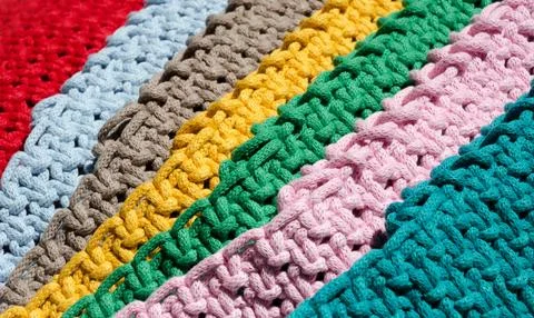 Knitting macrame, pattern of multi-colored cotton cords. Stock Photos