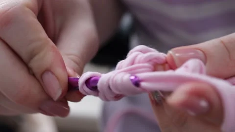 Knitting made of pink cotton threads. the girl knits Crochet Stock Footage 232607696