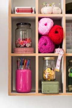 Knitting Materials Arranged Neatly in Rectangular Shelf Stock Photos