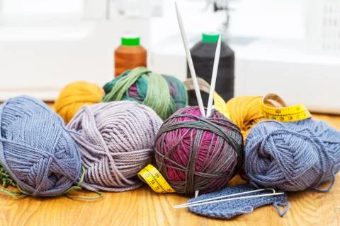Knitting materials on table and sewing machines Stock Photos