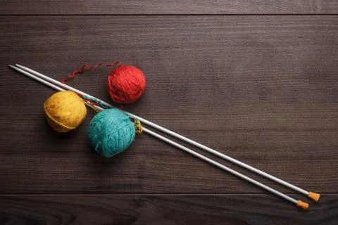 Knitting needles and ball of threads Stock Photos
