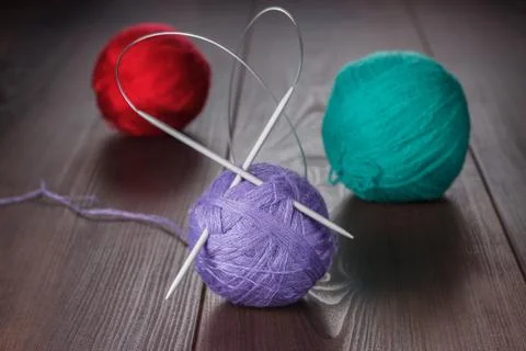 Knitting needles and balls of threads Stock Photos