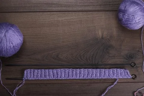 Knitting needles and balls of threads background Stock Photos
