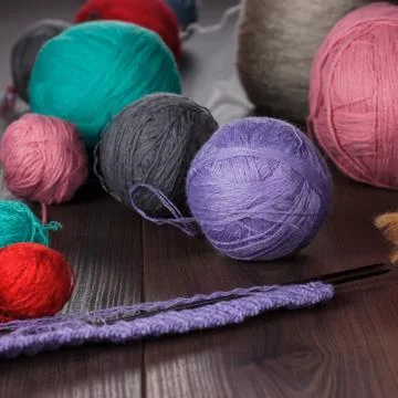 Knitting needles and balls of threads Stock Photos