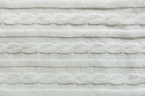 Knitting with needles. a pattern of braids of thread. background for the design. 스톡 사진