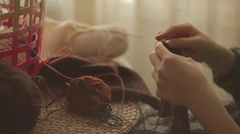 Knitting with needles by the table at home Stock-Footage 58777660