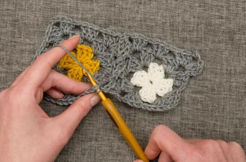 Knitting Patch of Crocheted Fabric with Flower Design Stock Photos