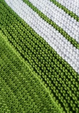 Knitting pattern in green and white cotton yarn, garter stitch. Stock Photos