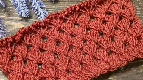 Knitting patterns with a raised pattern made of colored yarn lie on a wooden  Stock Photos