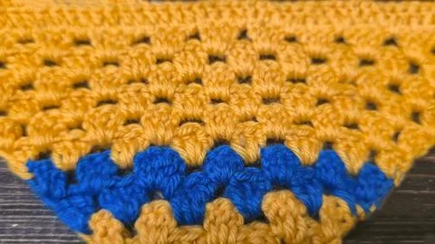 Knitting patterns with a relief pattern and yarn in different colors. Clothin Stock Photos