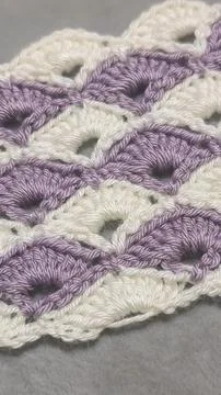 Knitting patterns for sweaters, hats, and other items using light-colored yar Fotos de archivo