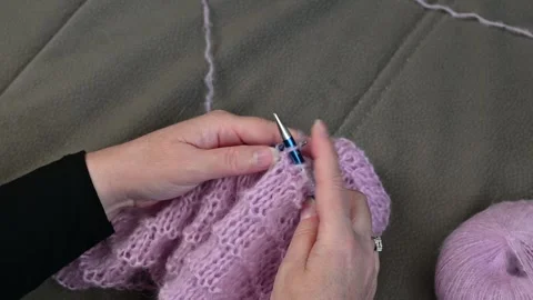 Knitting pink yarn loops, hands holding needles, soft wool texture close focu Stock Footage 334752174