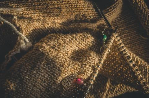 Knitting project close-up. Loops of yarn on the spokes. Knitting a warm sweater Stock Photos