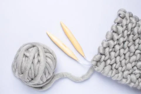 Knitting project in progress. A piece of knitting with ball of yarn and a Stock Photos
