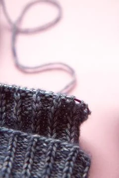 Knitting project underway. Blue knitting and knitting needles on light backgr Stock Photos