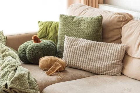 Knitting Setup with Yarn Basket and Cozy Sofa in Sunlit Living Room. Stock Photos