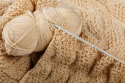Knitting spokes with ball of wool on table Stock Photos